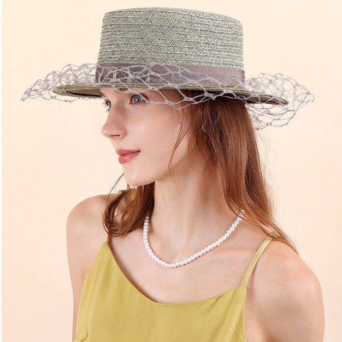 Raffia bucket hat in soft avocado green with decorative band