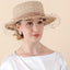 Model wearing beige coffee tone raffia hat with veil outdoors