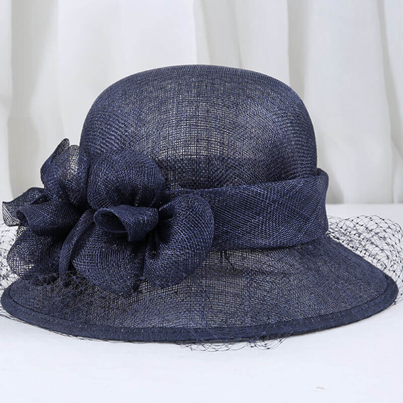 Dark Blue Sinamay derby hat with floral decoration and soft veil
