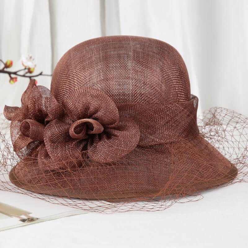 Light brown Sinamay summer derby hat with flower accents and veil