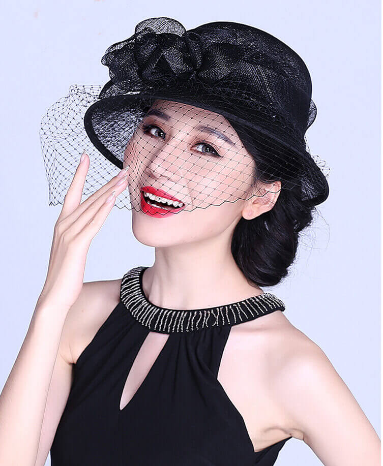 Black Sinamay derby hat with floral decoration and soft veil