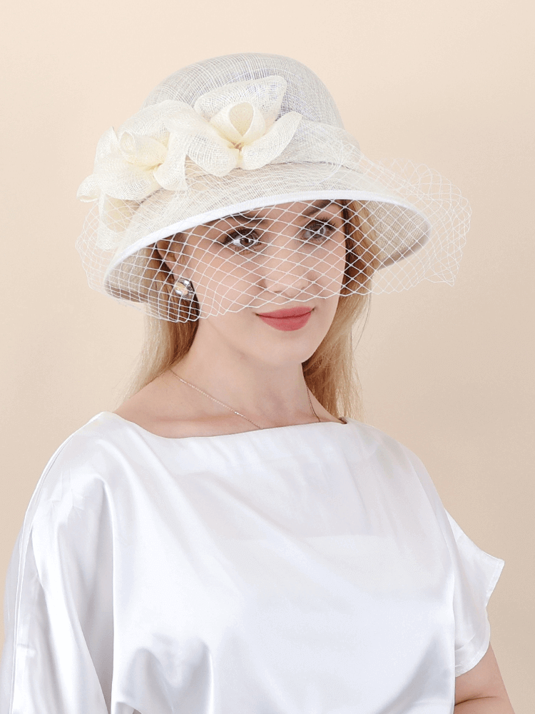 White Sinamay derby hat with floral decoration and soft veil